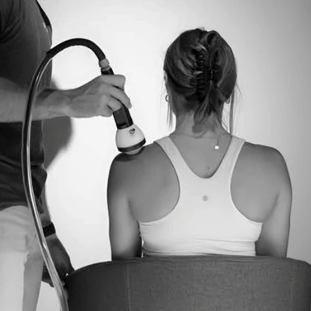 woman is receiving stemwave treatment on her left shoulder