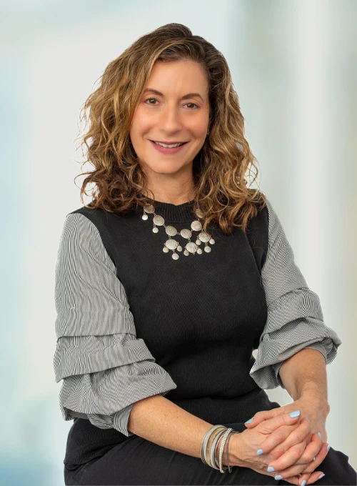 Debra Block Smiles Warmly at Patients Welcoming Them To the Clinic